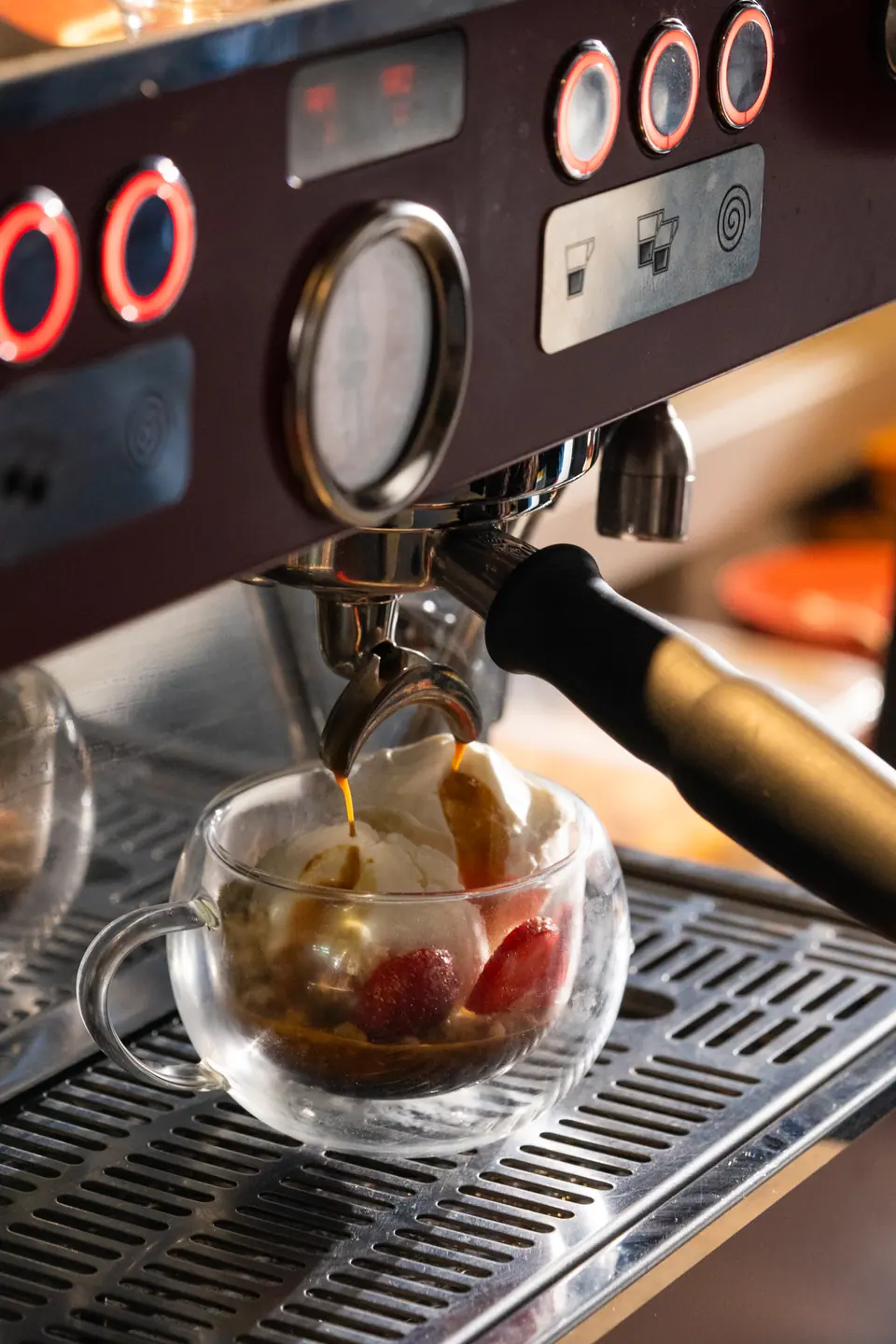 Espresso pouring from the burgundy machine over an affogato
